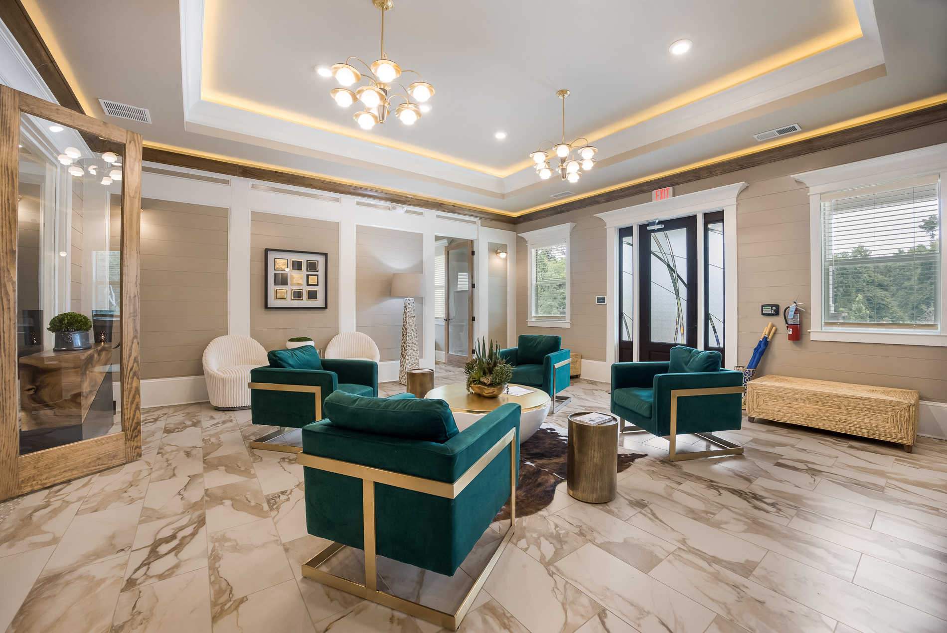 a living room with blue and white furniture and a marble floor