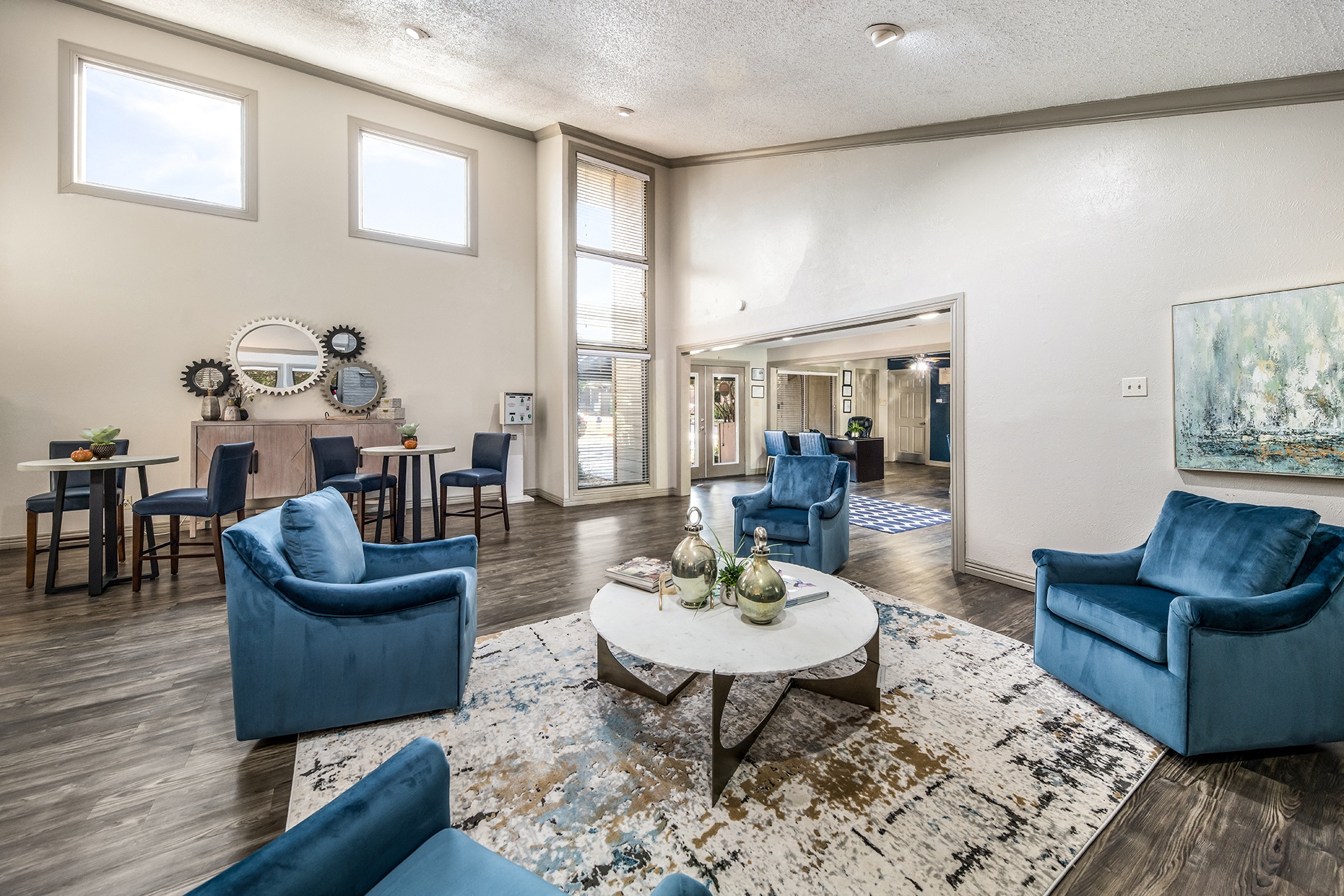 a living room with blue chairs and a coffee table
