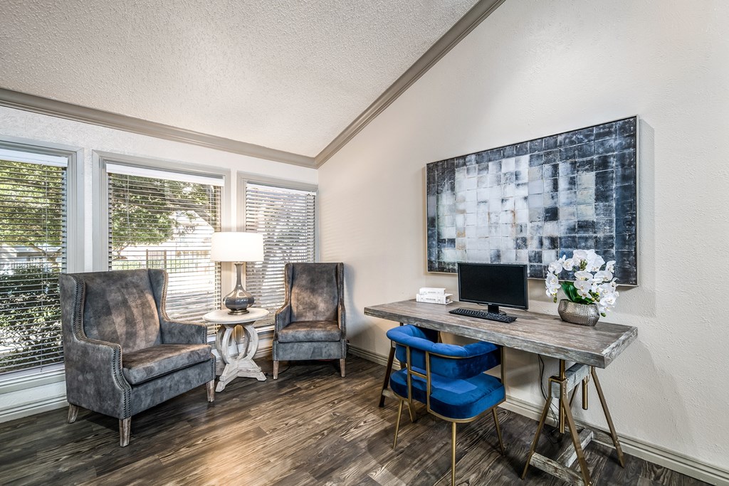 a home office with chairs and a desk with a computer