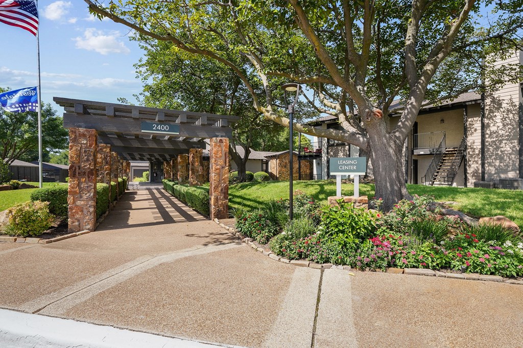 a view of the entrance to the community center with the american flag flying in the background