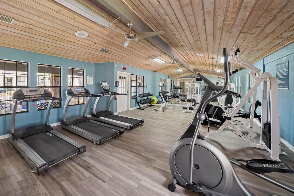 a gym with treadmills and other exercise equipment