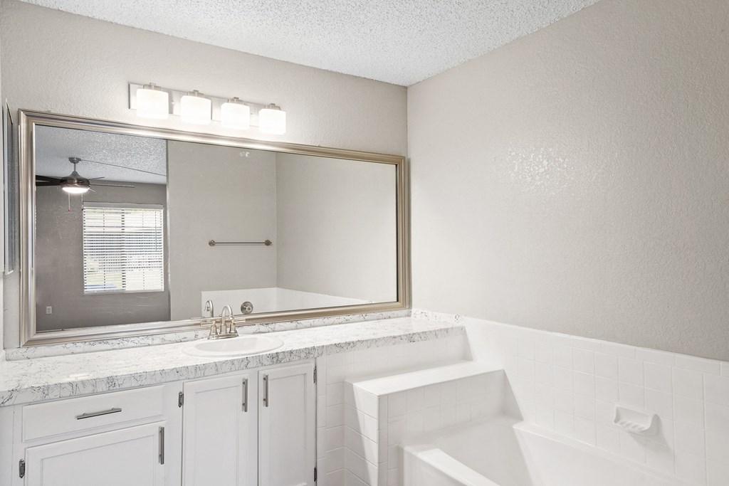 a bathroom with a bathtub and a sink