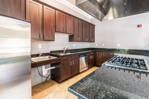 a kitchen with wood cabinets and stainless steel appliances and granite counter tops