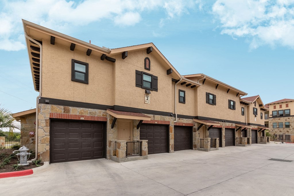 a building with three garages and a parking lot