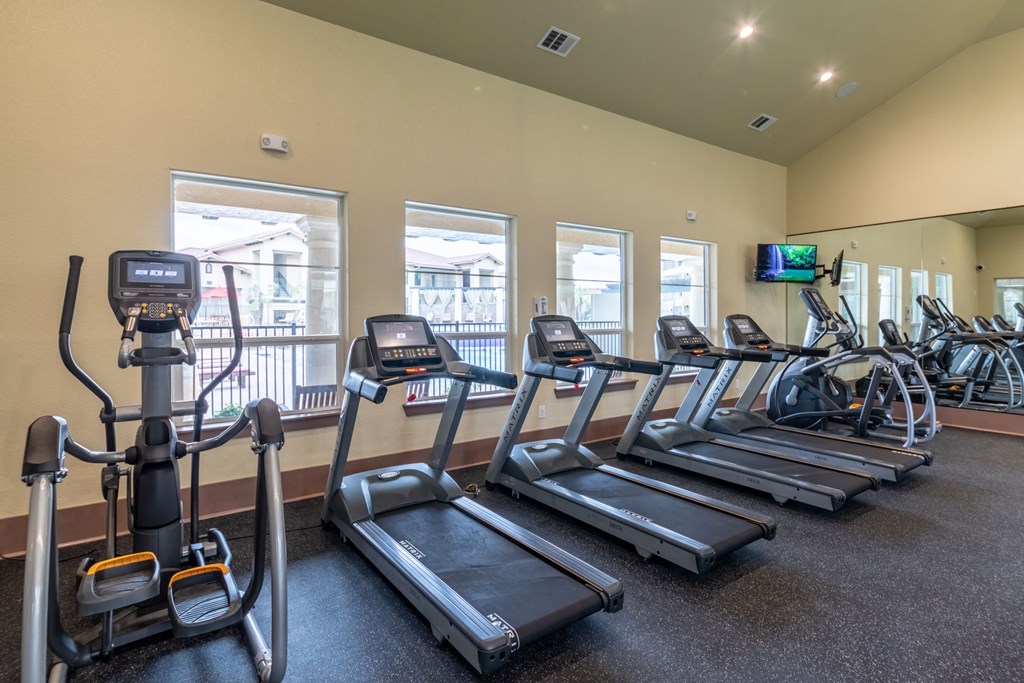 the gym with cardio equipment at the preserve at polk apartments