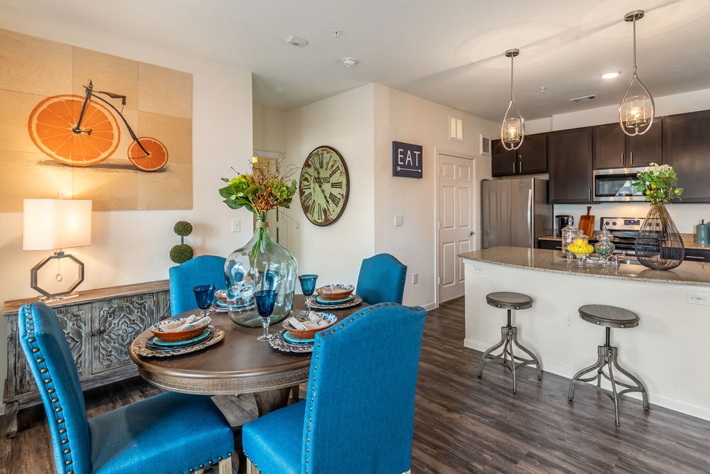 a dining room and kitchen with a table and chairs