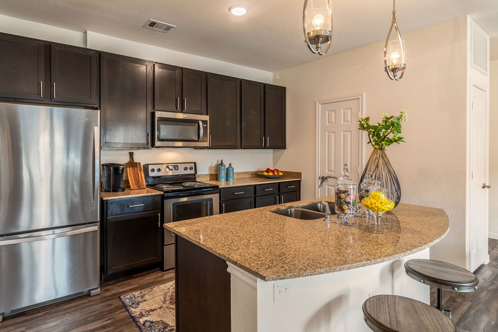 a kitchen with stainless steel appliances and a granite counter top