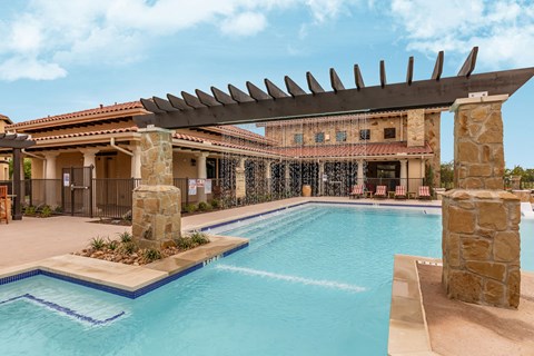 a swimming pool with a building in the background