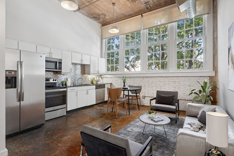 Futura Lofts living area with a kitchen and large windows