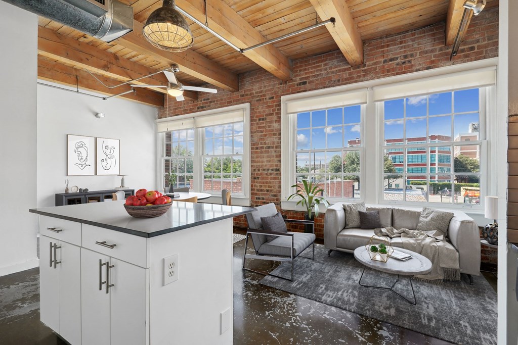 Deep Ellum Lofts Murray building virtually staged kitchen and living area with kitchen island and large windows | Deep Ellum Lofts in Dallas, TX