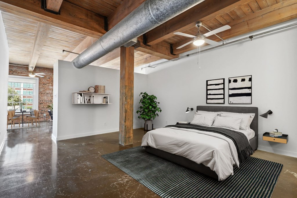 Deep Ellum Lofts Murray building virtually staged bedroom area With a ceiling fan and comfortable bed | Deep Ellum Lofts in Dallas, TX