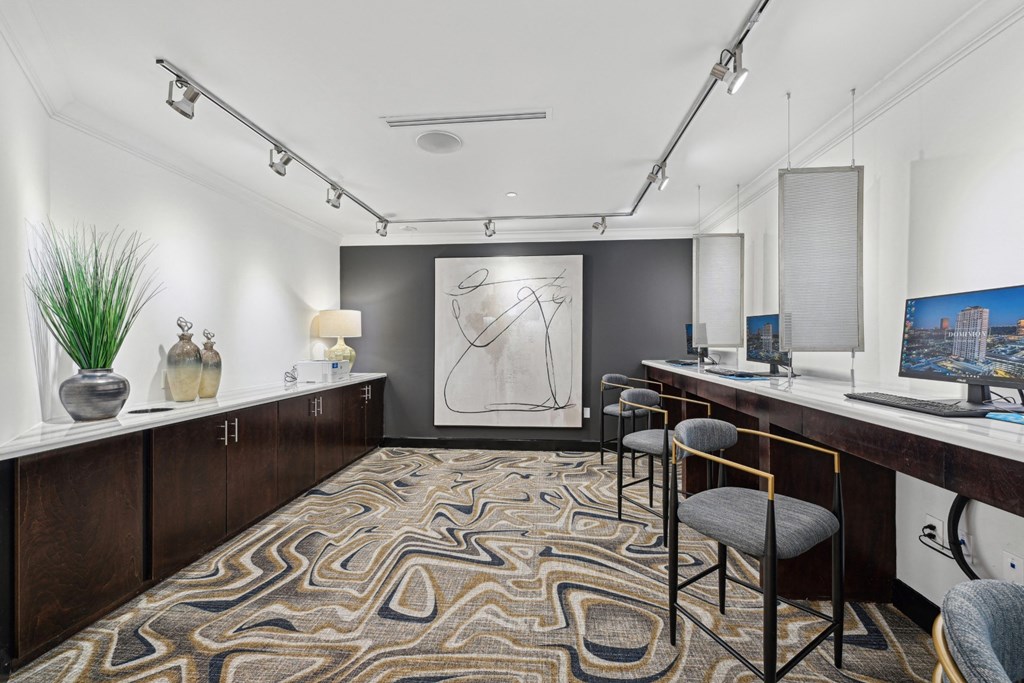 Sleek business center with 3 computers in frame at Dominion Post Oak apartments in Houston, TX