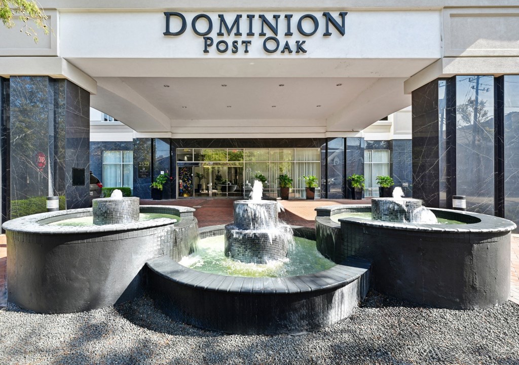 Main entrance to lobby with a fountain feature at Dominion Post Oak apartments in Houston, TX.