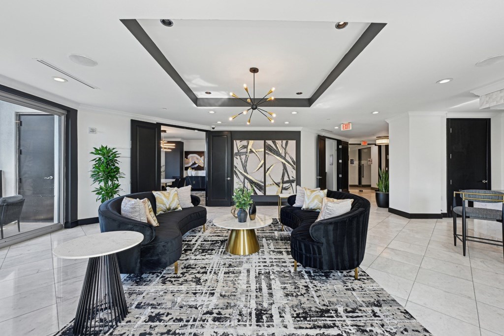 Resident lounge with two black couches at Dominion Post Oak apartments in Houston, TX