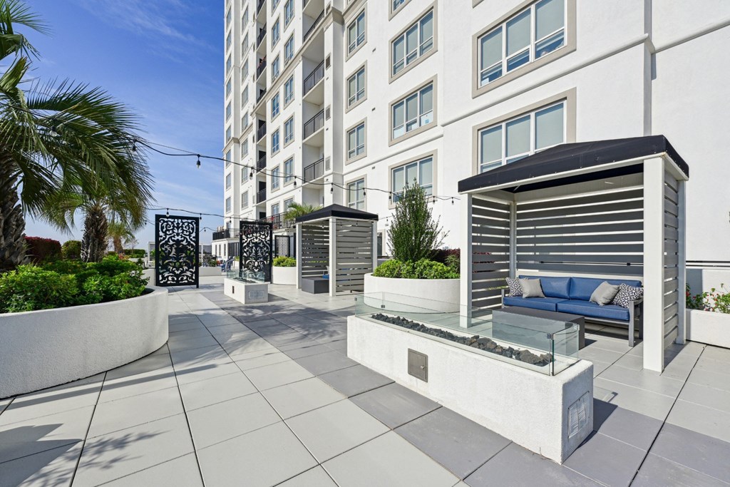 Relaxing outdoor cabanas with firepits in front at Dominion Post Oak apartments in Houston, TX