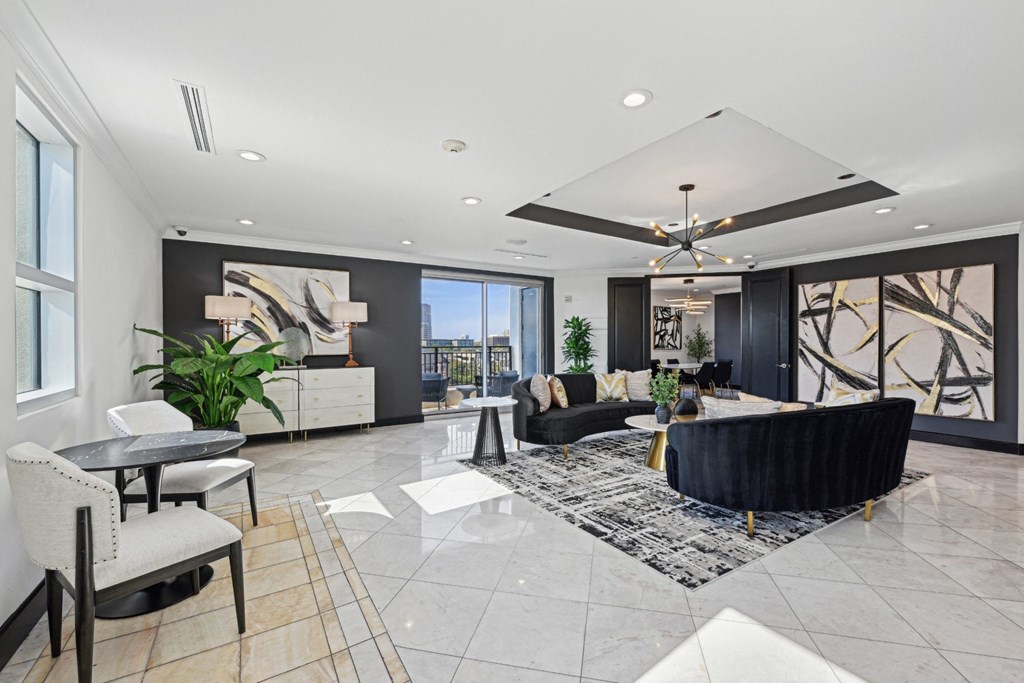 A spacious living room with a black and white color scheme.