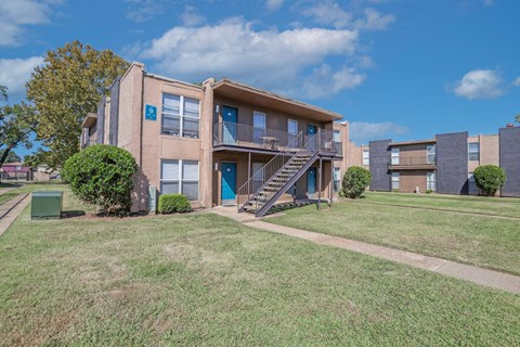 Apartment complex with a blue sky and clouds in the background at The Drake in Bossier City, LA