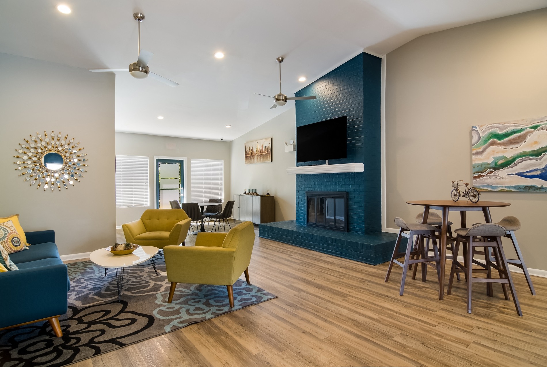 a living room with a fireplace and a table and chairs