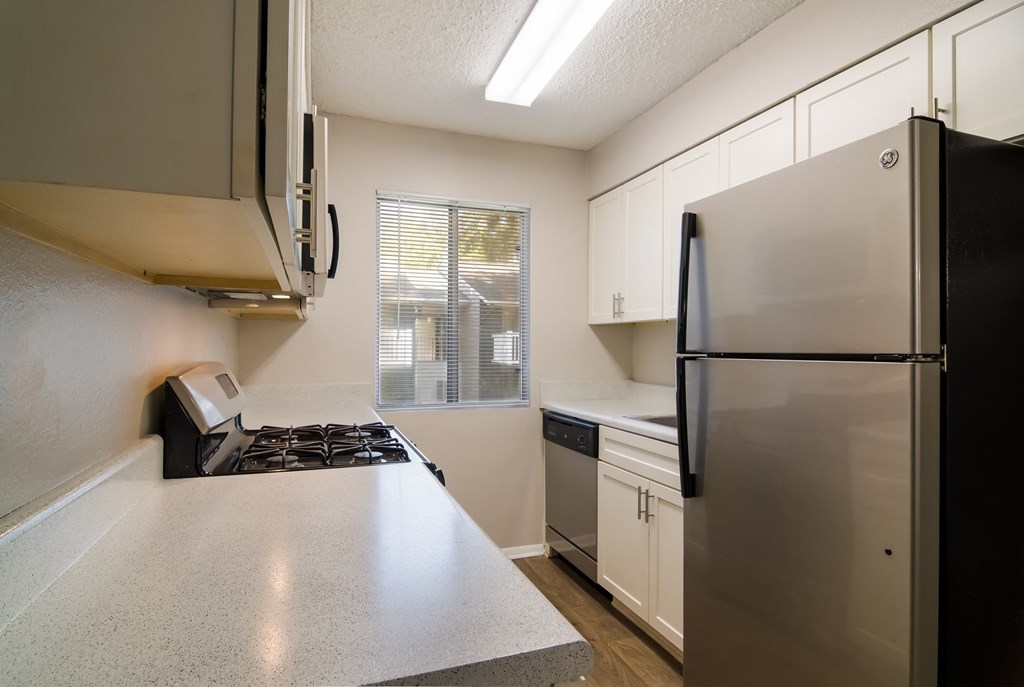 kitchen with marble countertop and a fridge at Dunwoody Pointe in Sandy Springs, GA