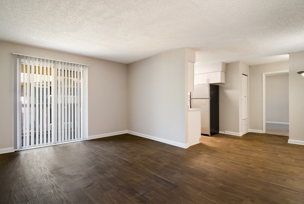 an empty living room with a large window at Dunwoody Pointe in Sandy Springs, GA