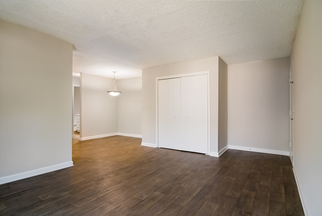 an empty living room with a hardwood floor and white walls at Dunwoody Pointe in Sandy Springs, GA