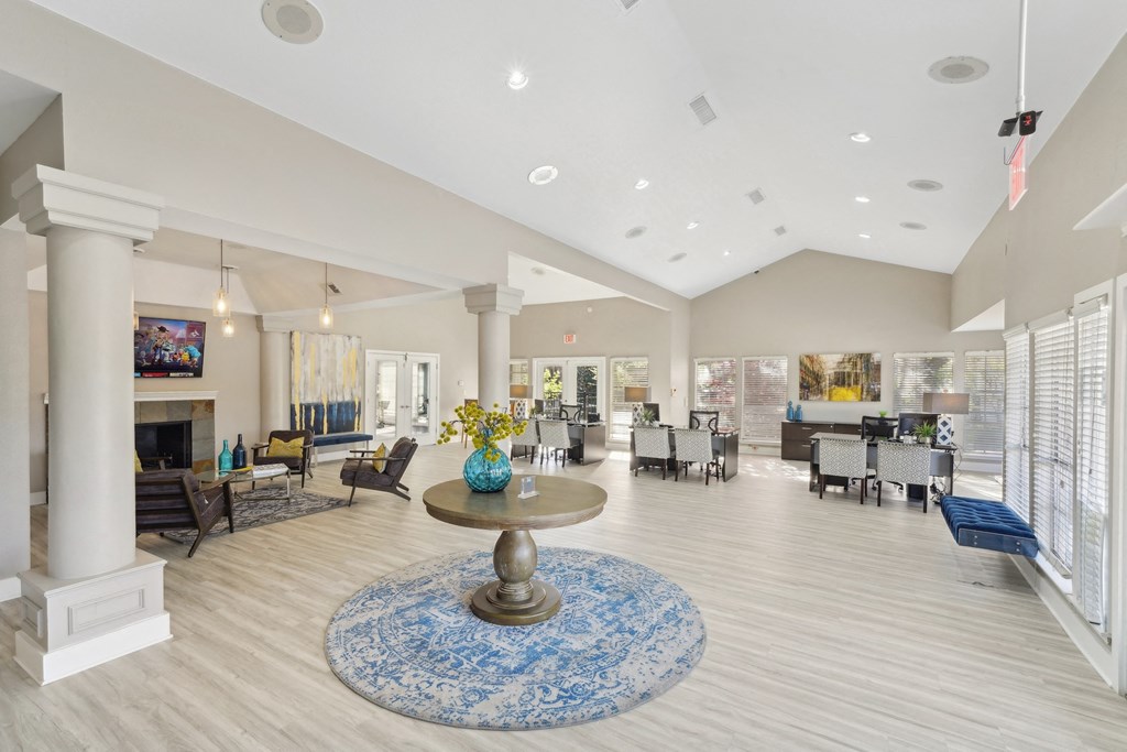 Interior of leasing office  with vaulted ceiling, office desks, and seating at Davenport Apartments in Dallas, TX