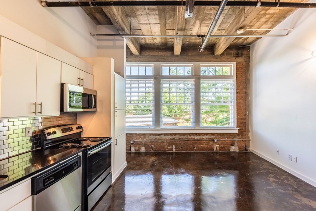 a kitchen with a stove top oven and a microwave