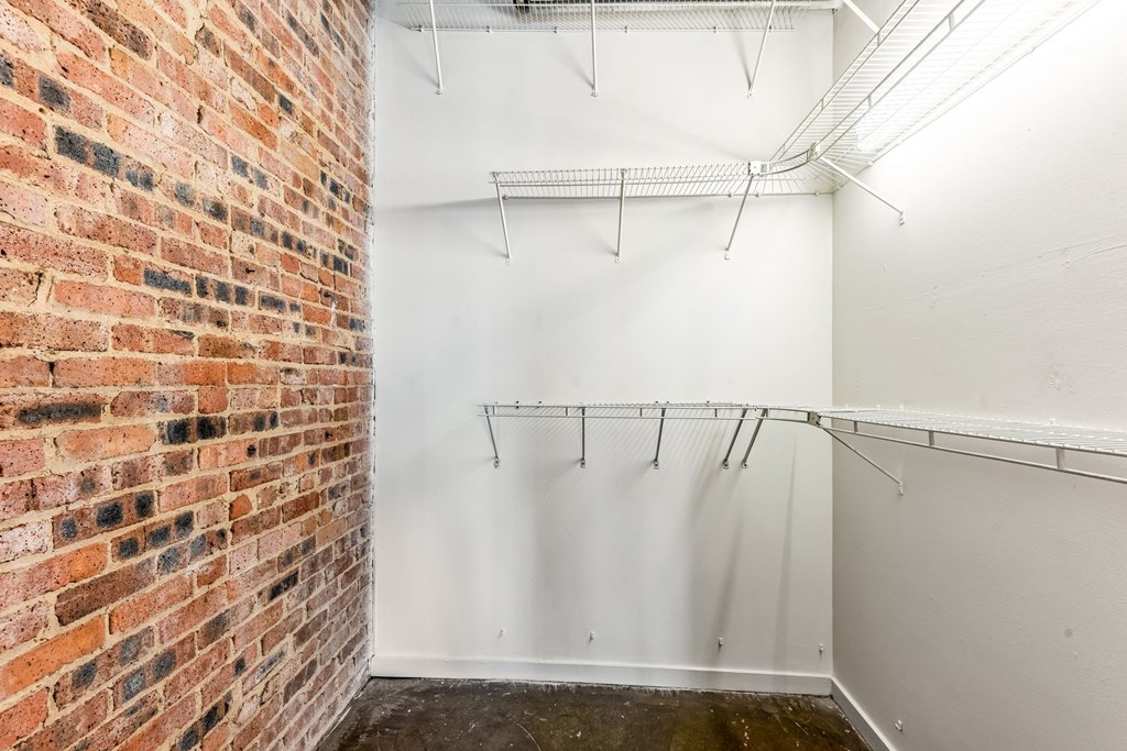 a room with a brick wall and white walls