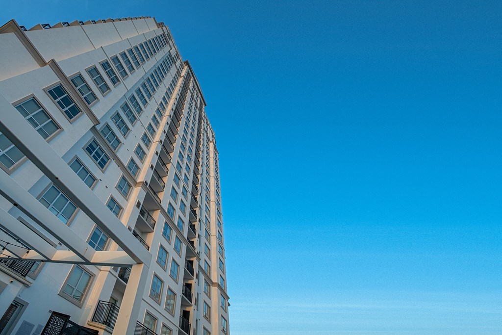 the tall apartment building with a blue sky in the background of Dominion Post Oak  in Houston, TX