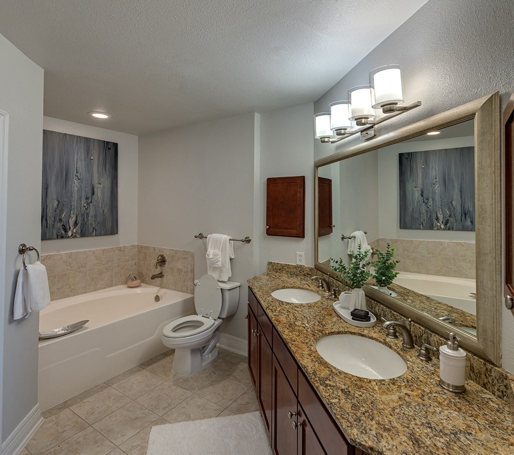 a bathroom with a bathtub and a toilet  in Houston, TX