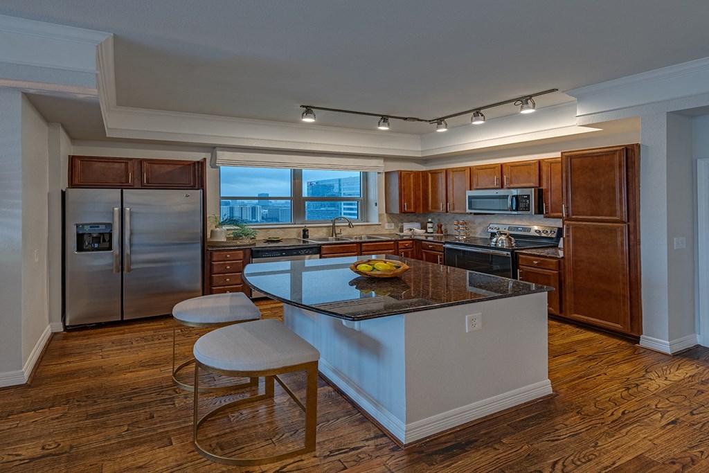 a kitchen with an island and two stools  in Houston, TX