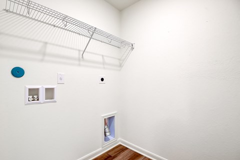 the laundry room with a closet and a shelf on the wall