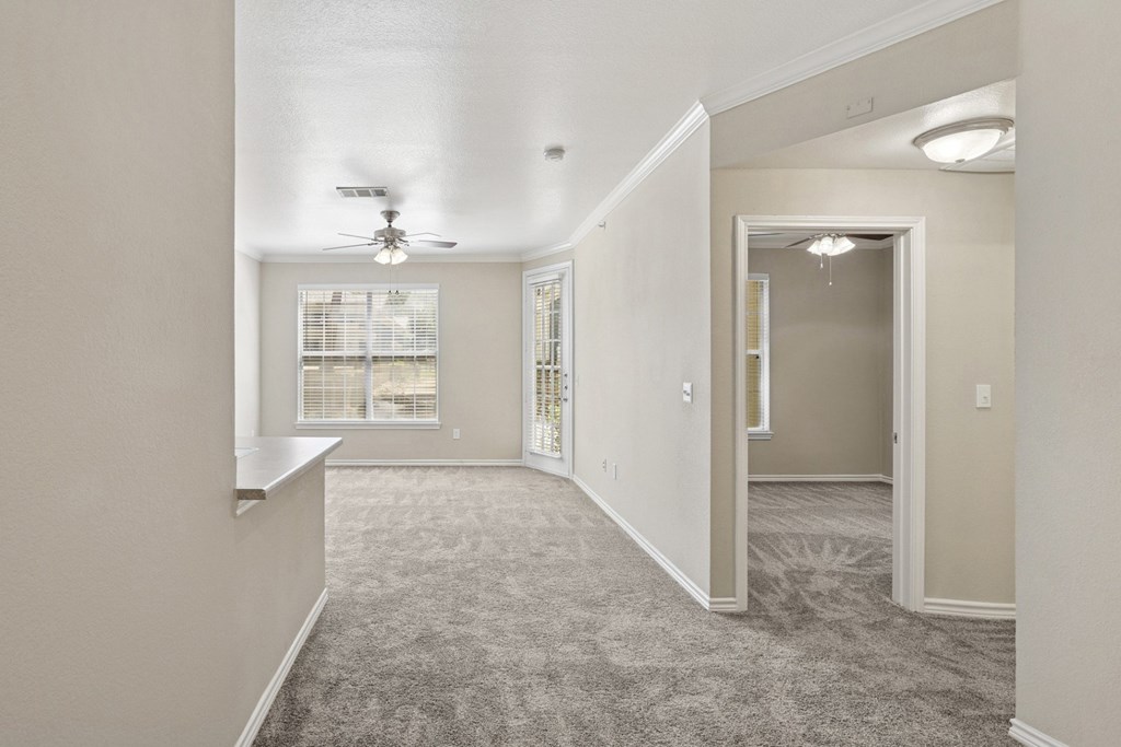 Edinburgh living room  with a carpeted floor and a ceiling fan at Encore at Buckingham Apartments in Richardson, TX
