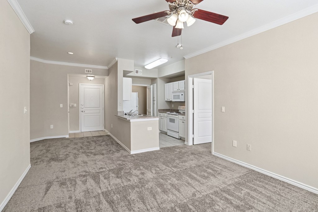 Edinburgh living room with carpet and a ceiling fan at Encore at Buckingham Apartments in Richardson, TX