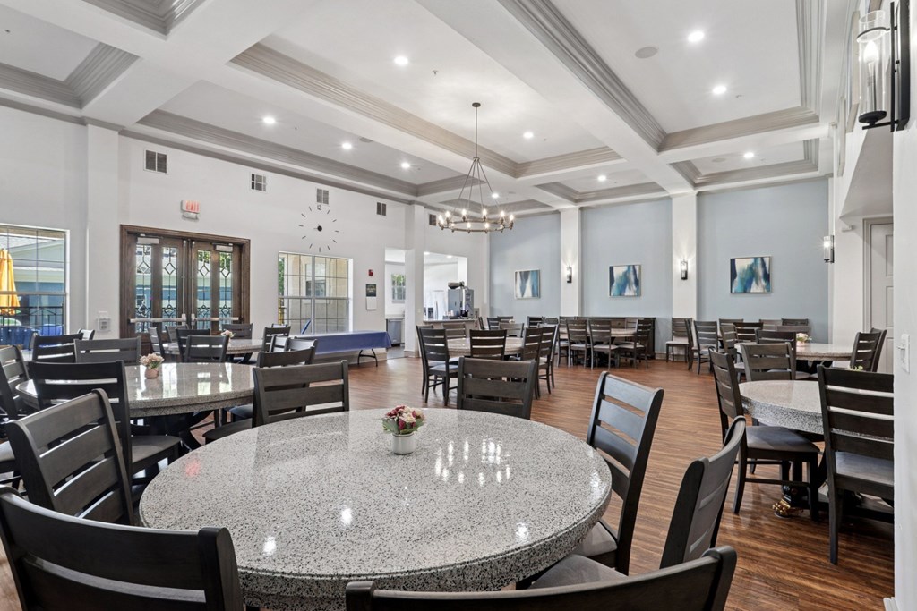 A large event room with round tables and chairs at Encore at Buckingham Apartments in Richardson, TX