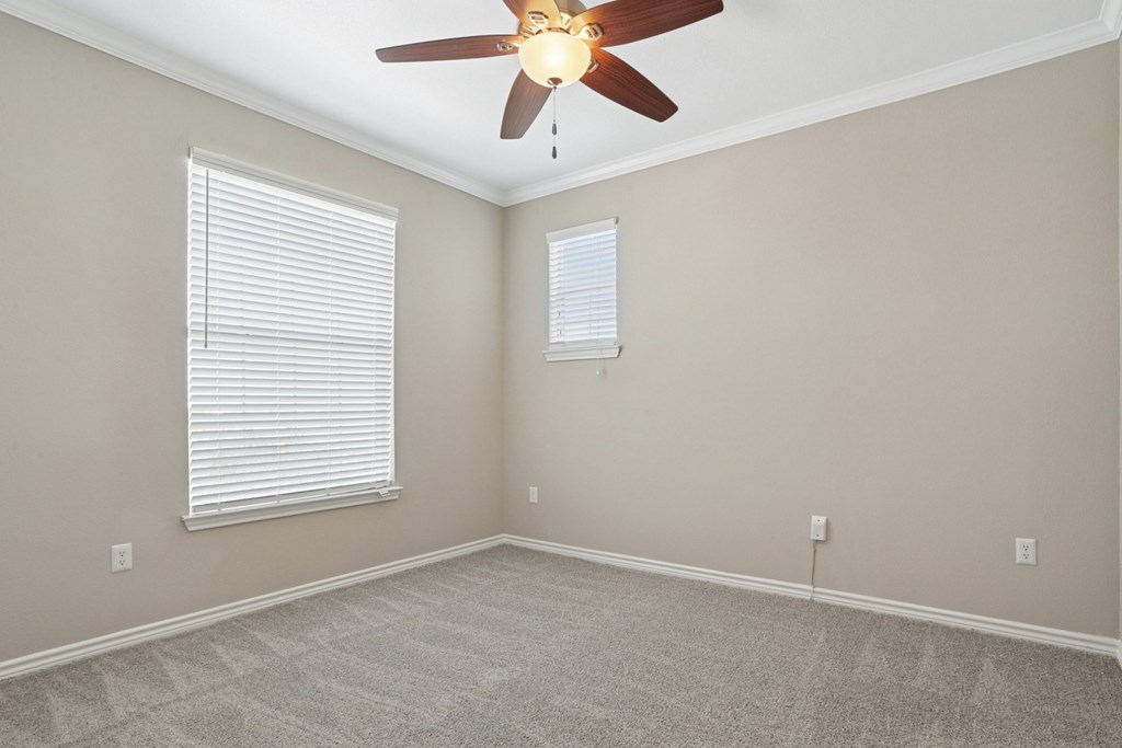 Kenzington bedroom with carpet and a ceiling fan at Encore at Buckingham Apartments in Richardson, TX