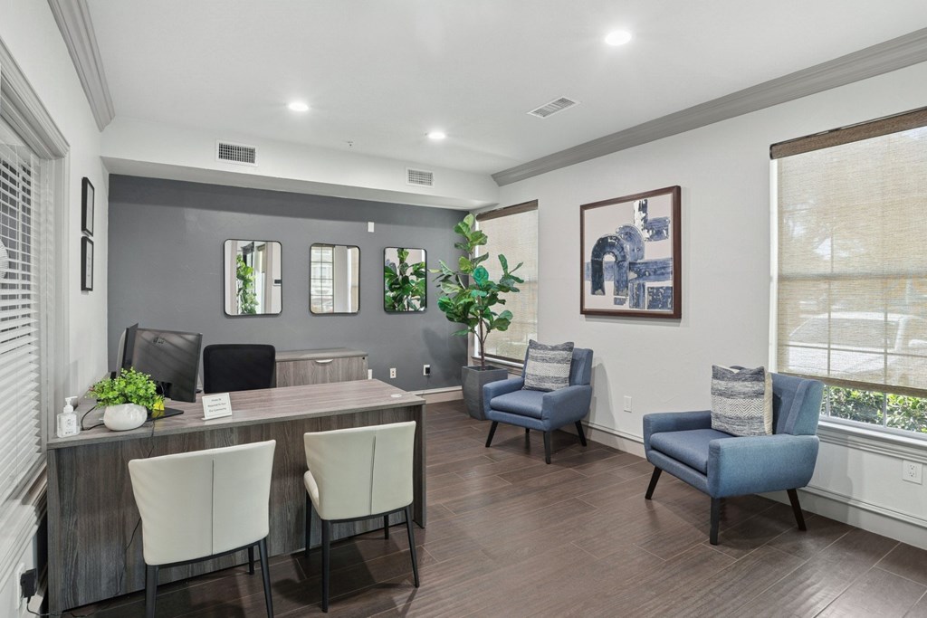 A leasing office with a desk and chairs at Encore at Buckingham Apartments in Richardson, TX