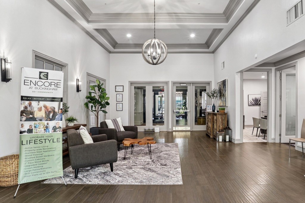 A leasing office with chairs and a rug at Encore at Buckingham Apartments in Richardson, TX