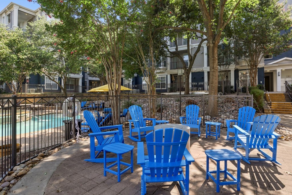 Outdoor seating near the pool at Encore at Buckingham Apartments in Richardson, TX
