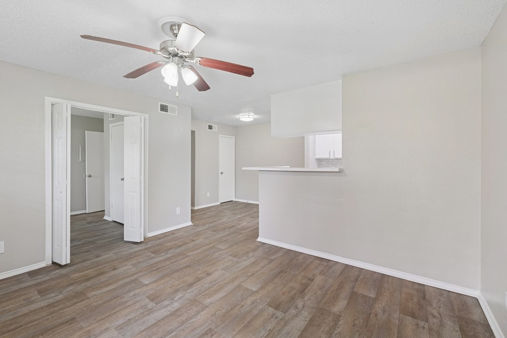 A3 living room with a ceiling fan and wood flooring at Estelle Creek North Apartments in Irving, TX