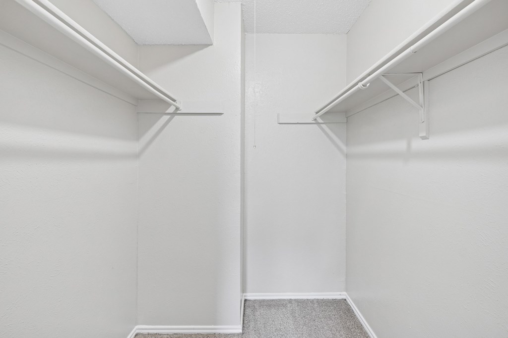 B1 white closet with shelves and carpeting at Estelle Creek North Apartments in Irving, TX