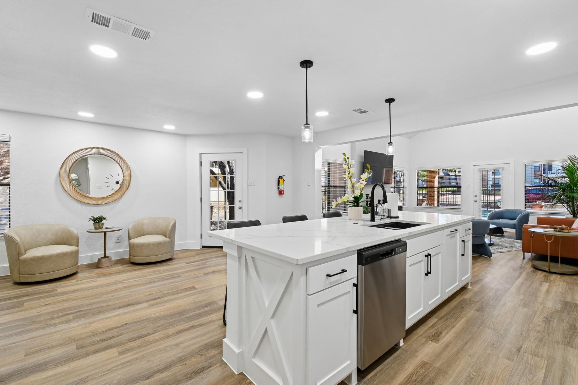 A modern kitchen with white cabinets and a large island.