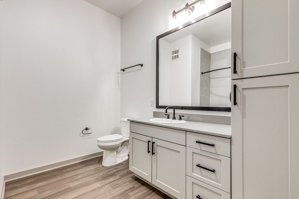 a bathroom with white appliances at Era Apartment in Denton, TX