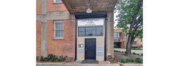 a building with a black door and a white sign that says ell street lofts
