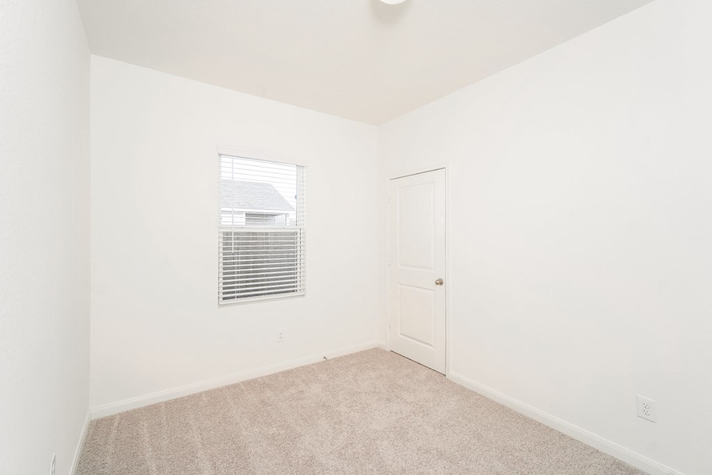 a bedroom with white walls and carpet at Beacon at Meridian, San Antonio, TX