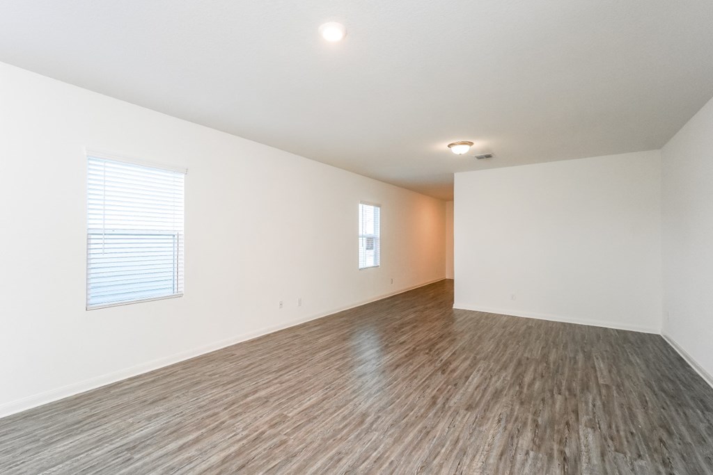 a bedroom with hardwood floors and white walls at Beacon at Meridian, Texas, 78245