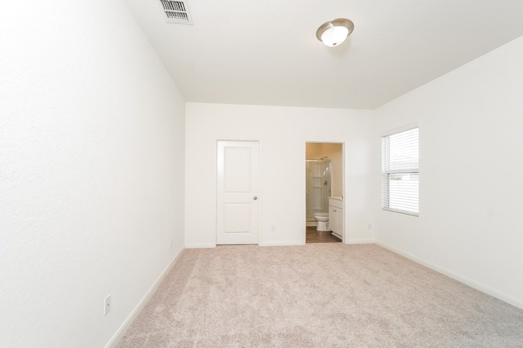 a bedroom with white walls and carpet at Beacon at Meridian, San Antonio, TX