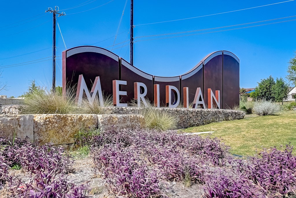 a sign that says meridian with purple flowers in front of it at Beacon at Meridian, Texas, 78245