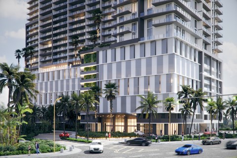 A modern building with a parking lot in front of it.