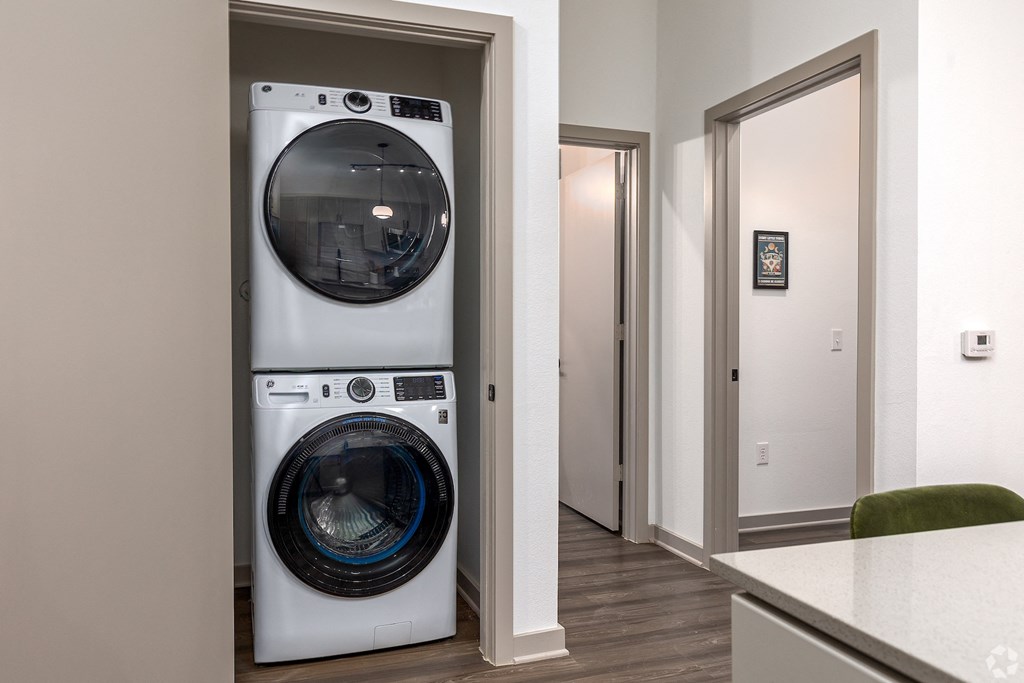 Stackable front loading washer and dryer in the apartment at Era apartments in Denton, TX